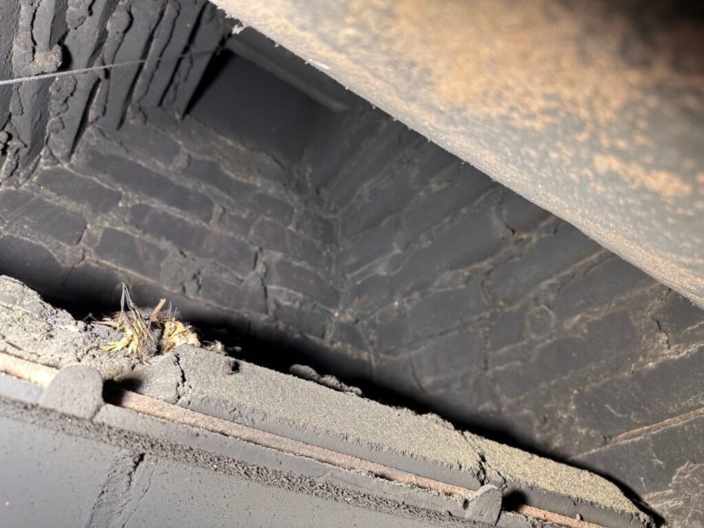 Before: sooty, uncoated smoke chamber brick with visible gaps, Morristown, NJ