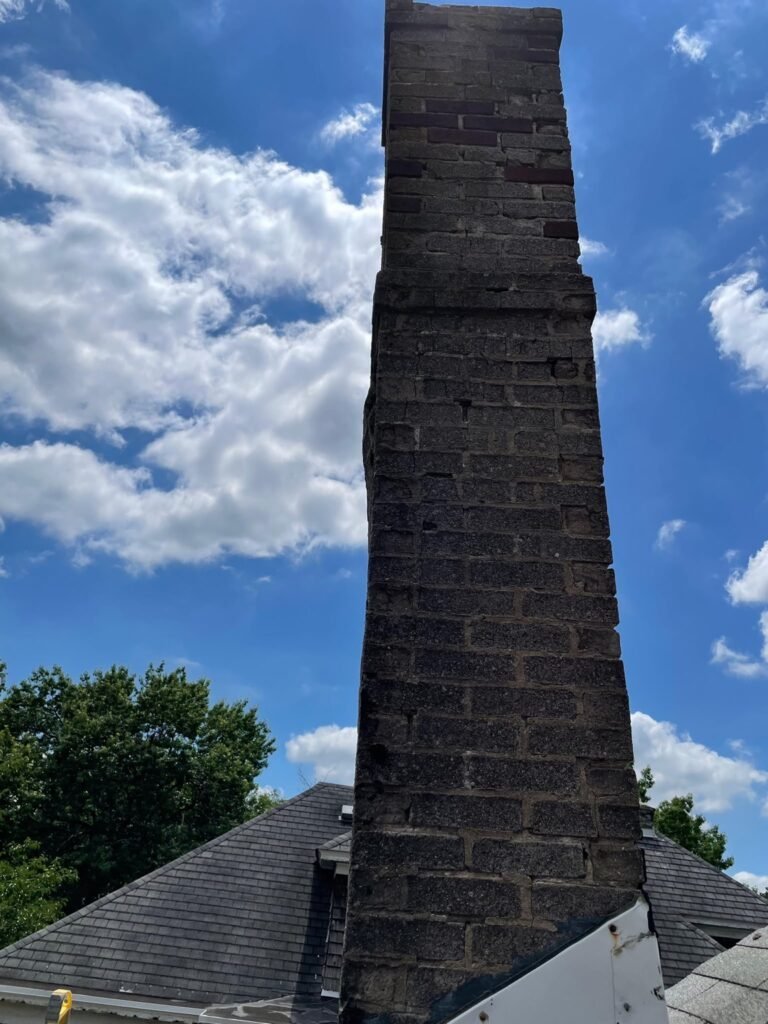 Close-up of the original brick chimney with worn mortar joints